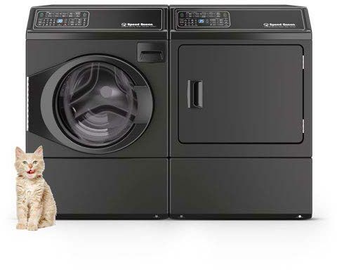 A cat is sitting next to a pair of matte black Speed Queen laundry appliances.