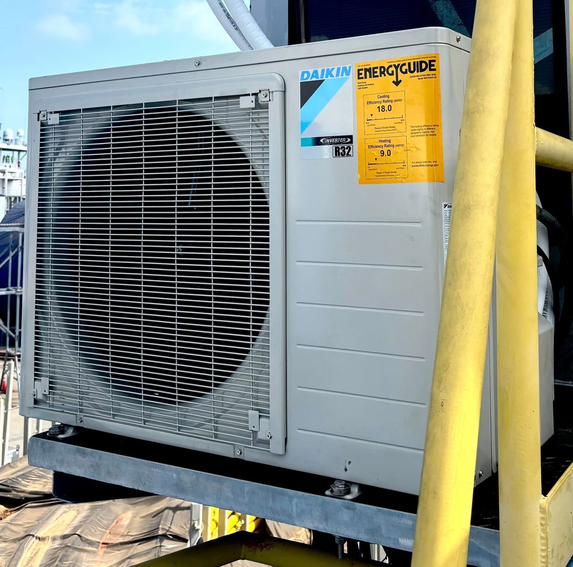 A daikin air conditioner with a yellow sticker on it