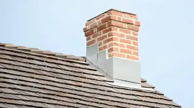 A brick chimney on top of a roof.