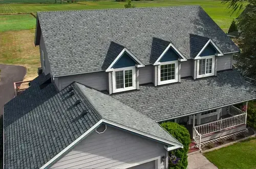 An aerial view of a house with a gray roof.