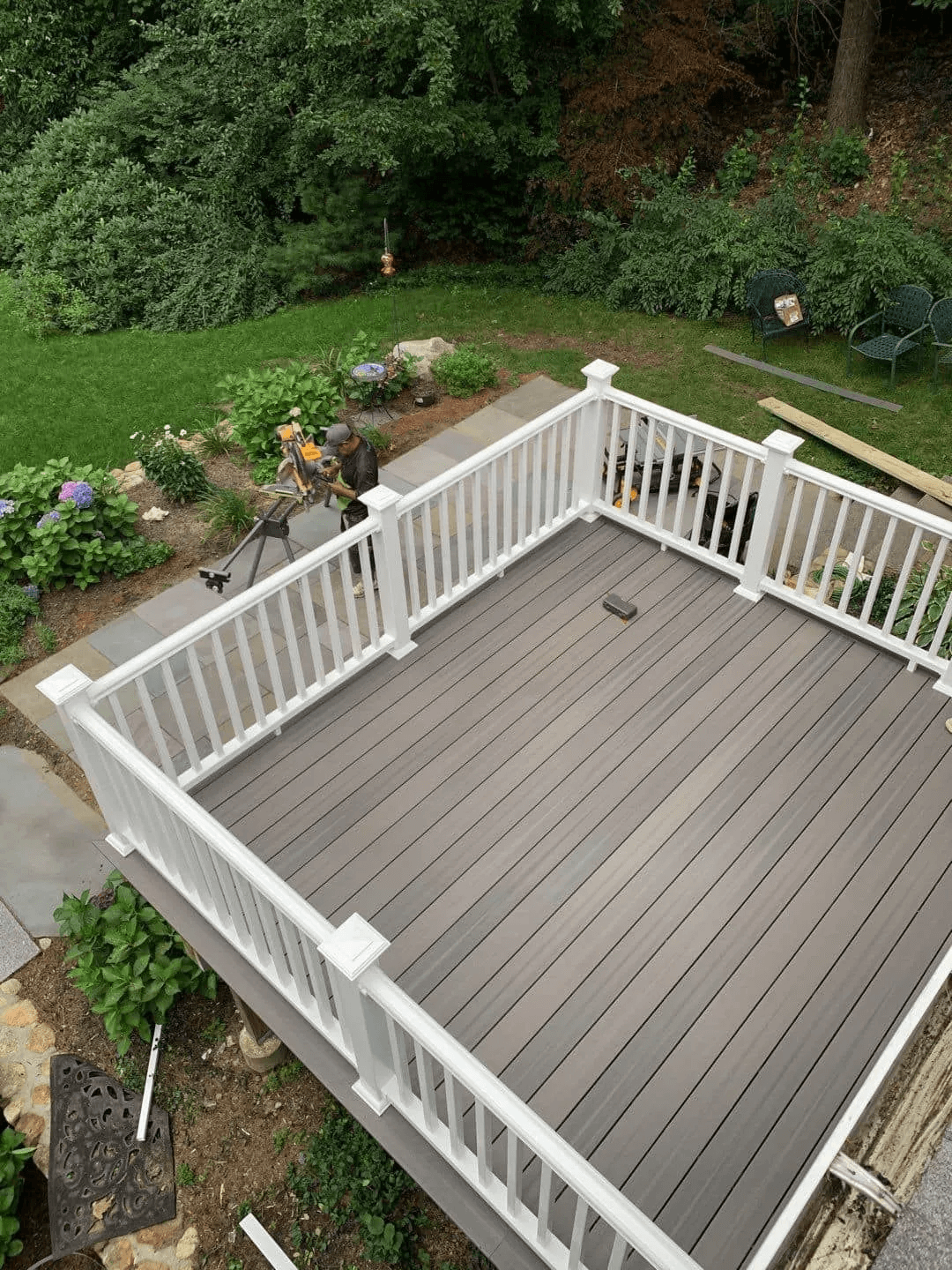 An aerial view of a composite deck with a white railing.