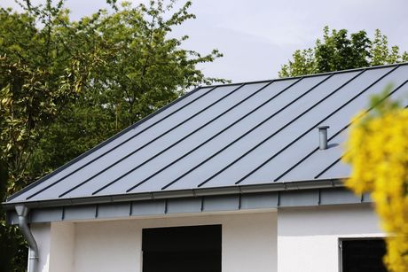 A close up of a metal roof with a few holes in it.