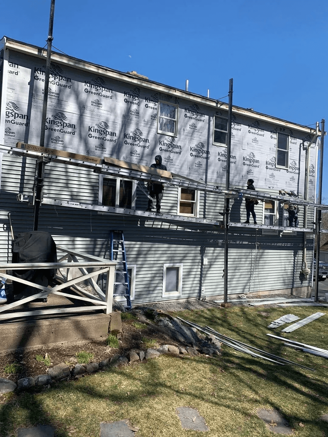A house is being remodeled with siding and windows.