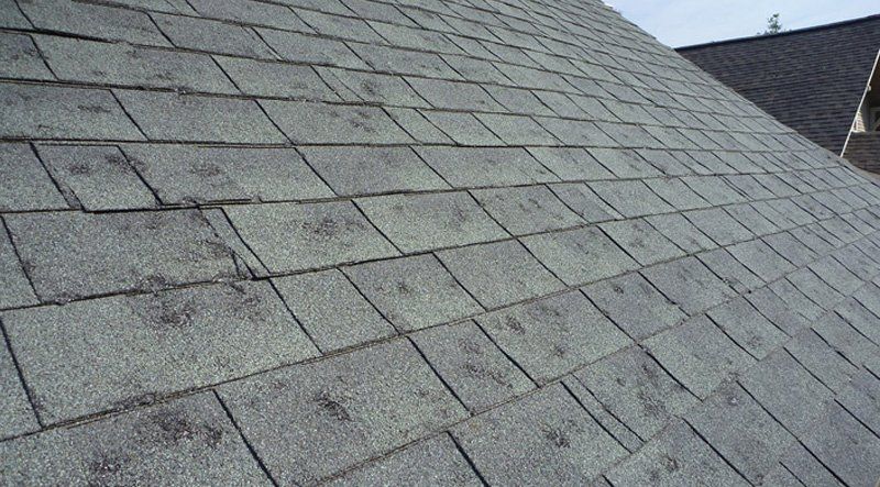 A close up of a roof with a lot of shingles on it.