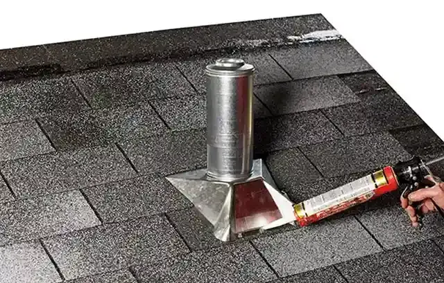 A person is applying sealant to a roof.