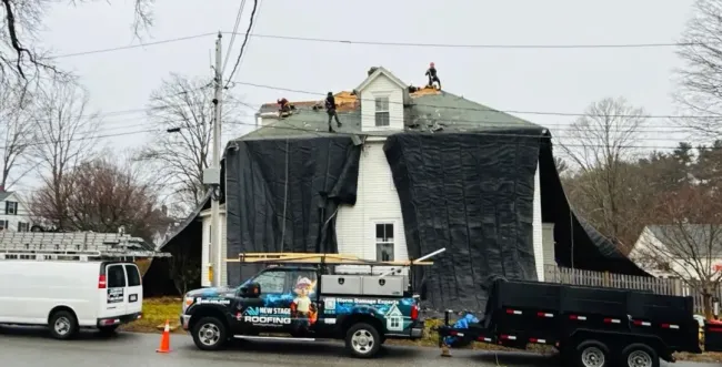 A tree has fallen on a power line in front of a house.