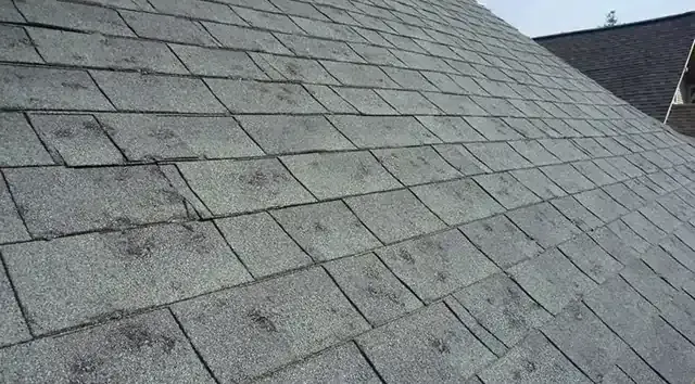 A close up of a roof with a lot of shingles on it.