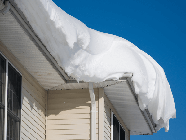 A house with a lot of snow on the roof