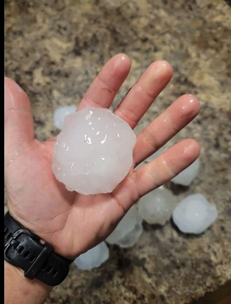 A person is holding a large piece of ice in their hand — Holmen, WI — Riverland Exteriors Corporation