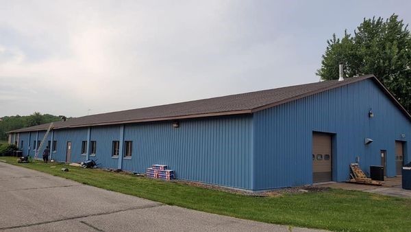 A large blue building with a brown roof — Holmen, WI — Riverland Exteriors Corporation