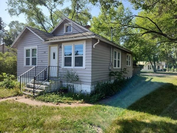 A small house with a lot of windows is surrounded by trees and grass — Holmen, WI — Riverland Exteriors Corporation