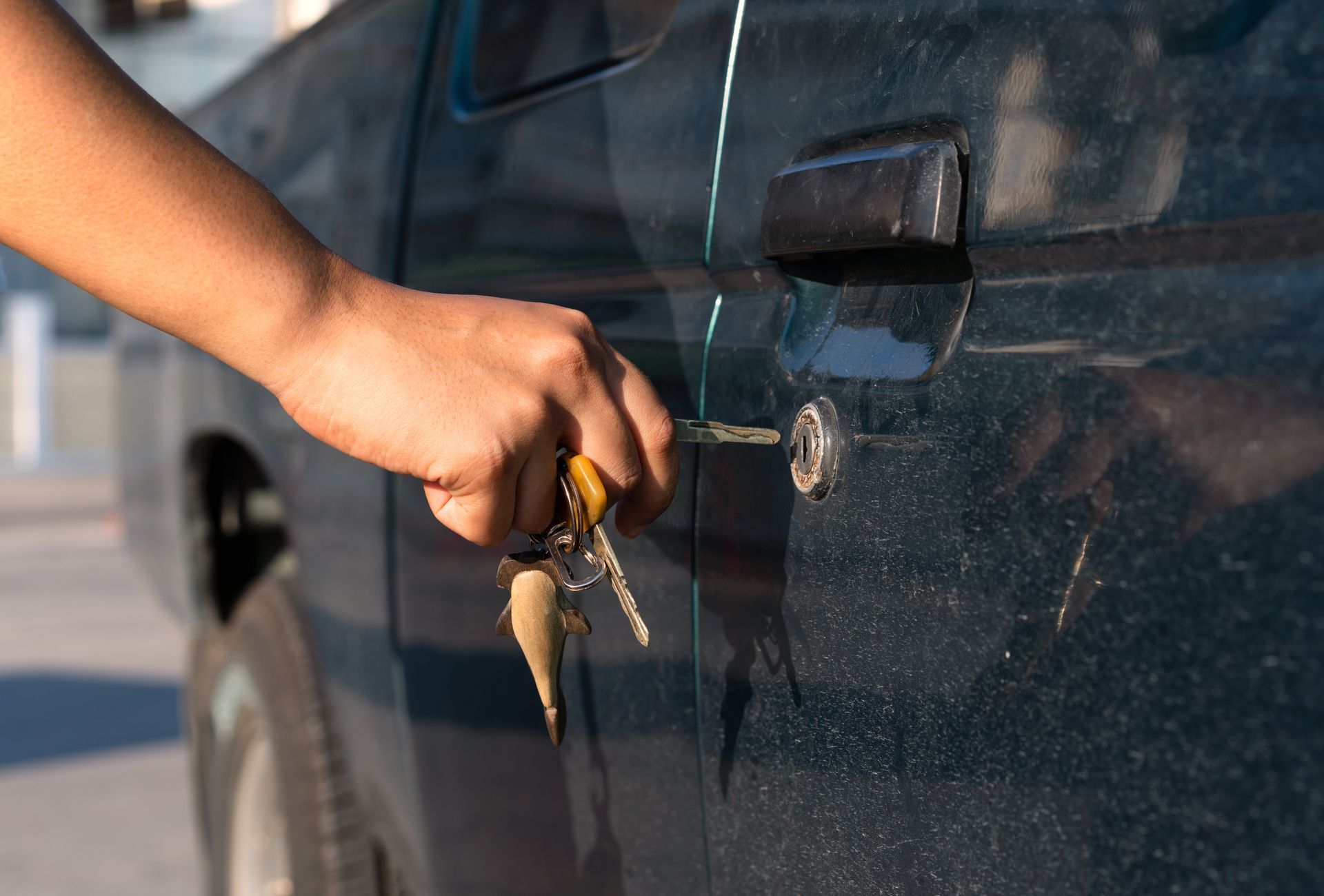 A man is fixing the door lock of a car.