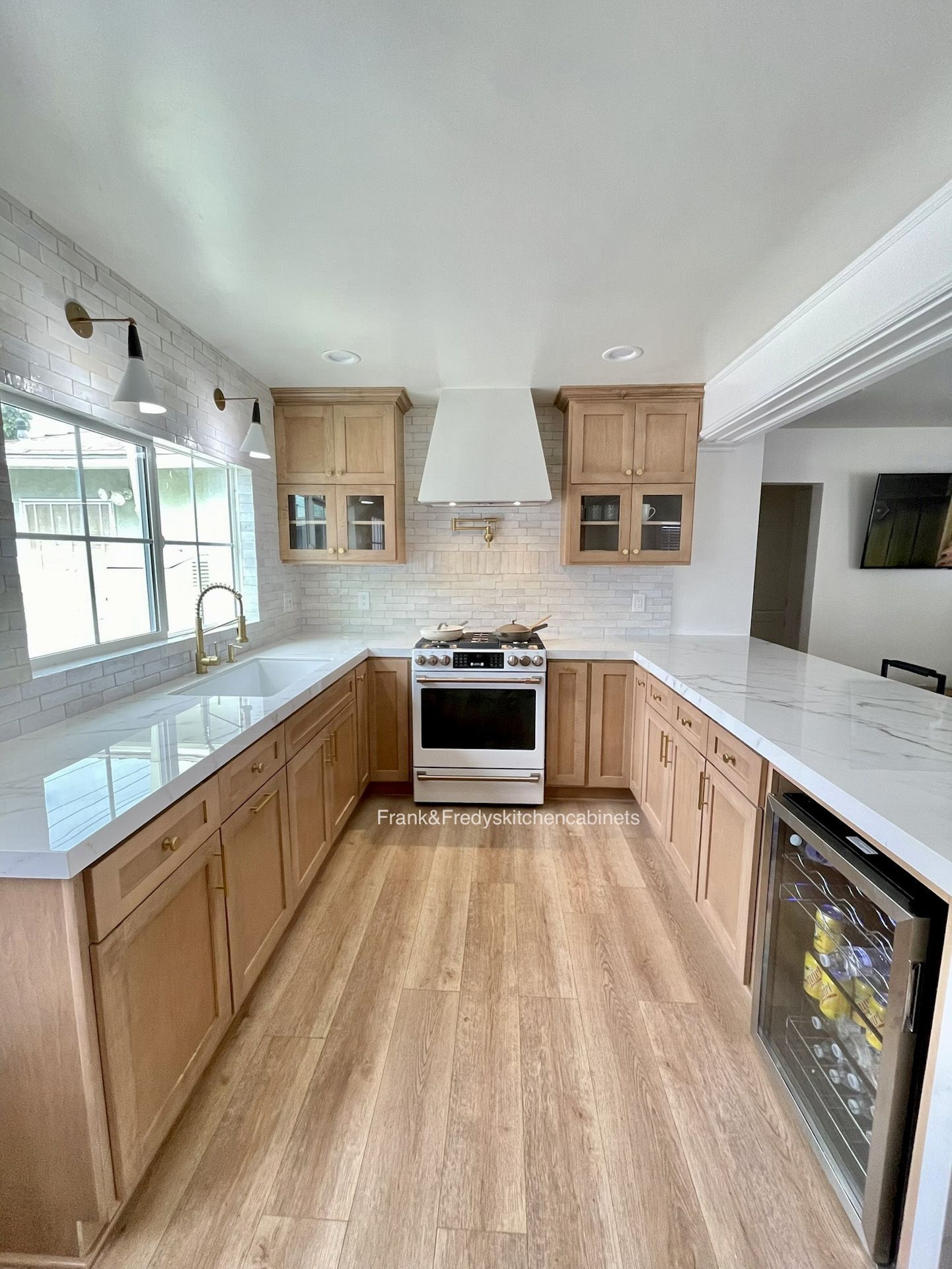 A kitchen with wooden cabinets, white counter tops, a stove and a refrigerator.