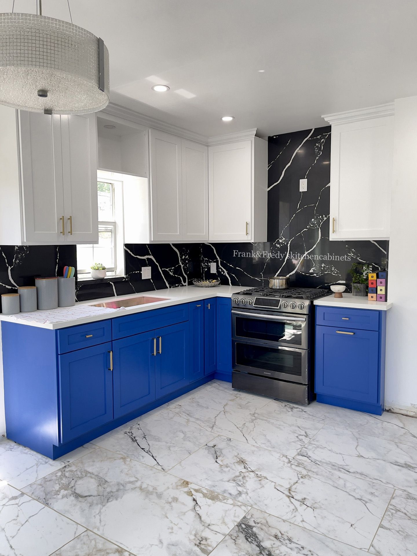 A kitchen with blue cabinets and white counter tops.