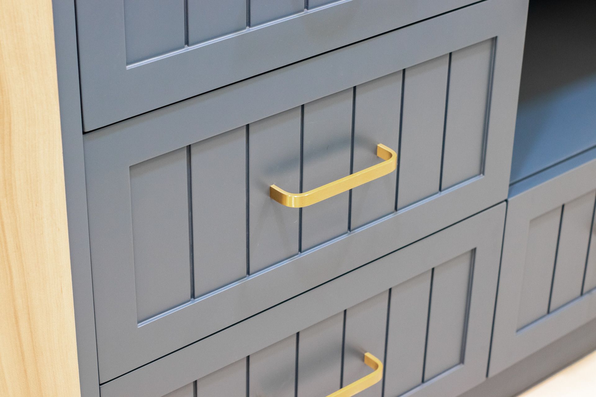 A close up of a gray cabinet with yellow handles