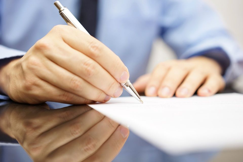 Man Signing Letter — Ripley, TN — S.N. Anthony Insurance Inc.