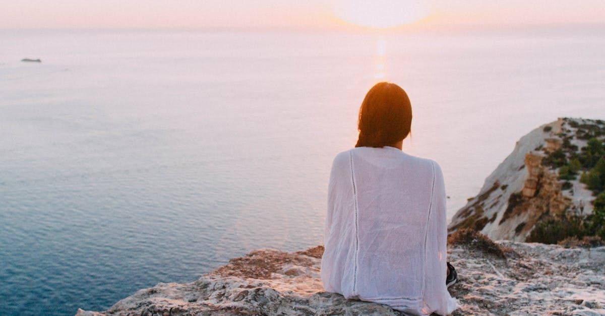 Mental Health SEO, image of woman sitting serenely on the beach 
