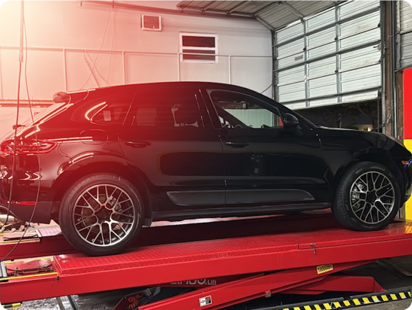 car on lift in garage - Jimmy's German Auto Repair