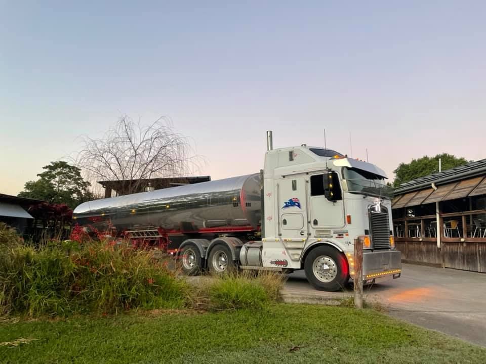 A White Semi Truck Is Parked in Front of A Building — Stolzenberg Water Carriers in Curra, QLD