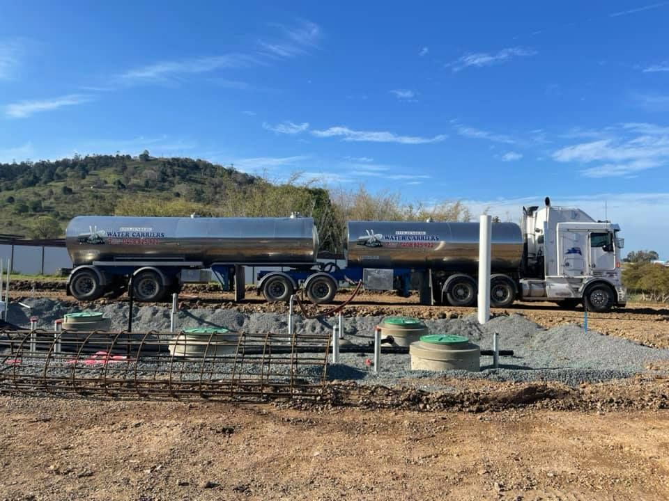 A Large Tanker Truck Is Parked in A Dirt Field — Stolzenberg Water Carriers in Chatsworth, QLD