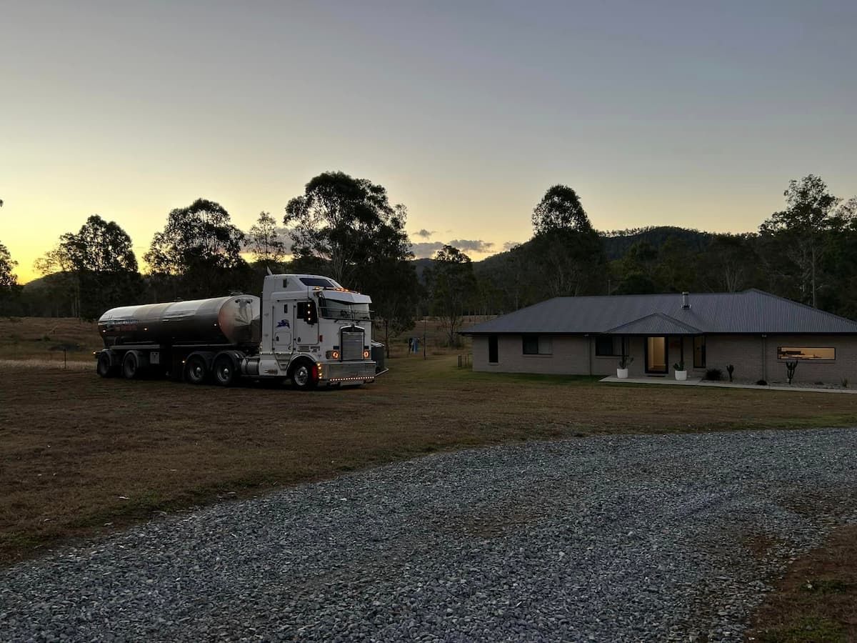 A White Truck Is Parked in Front of A House — Stolzenberg Water Carriers in Chatsworth, QLD