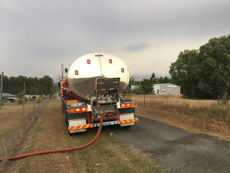 A Tanker Truck with A Hose Attached to It Is Parked on The Side of The Road — Stolzenberg Water Carriers in Chatsworth, QLD