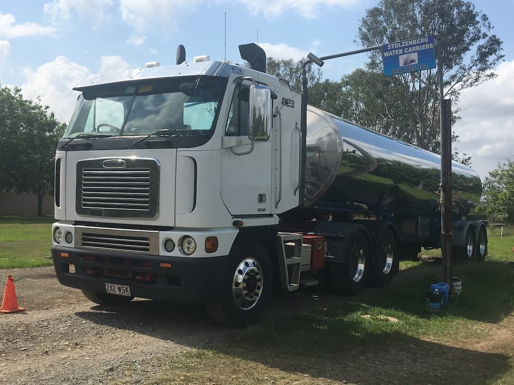 A Large White Truck Is Parked on The Side of The Road — Stolzenberg Water Carriers in Chatsworth, QLD