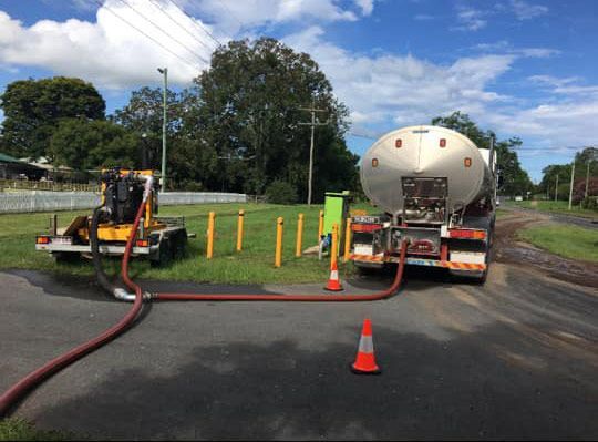 A Tanker Truck with A Hose Attached to It Is Parked on The Side of The Road — Stolzenberg Water Carriers in Chatsworth, QLD