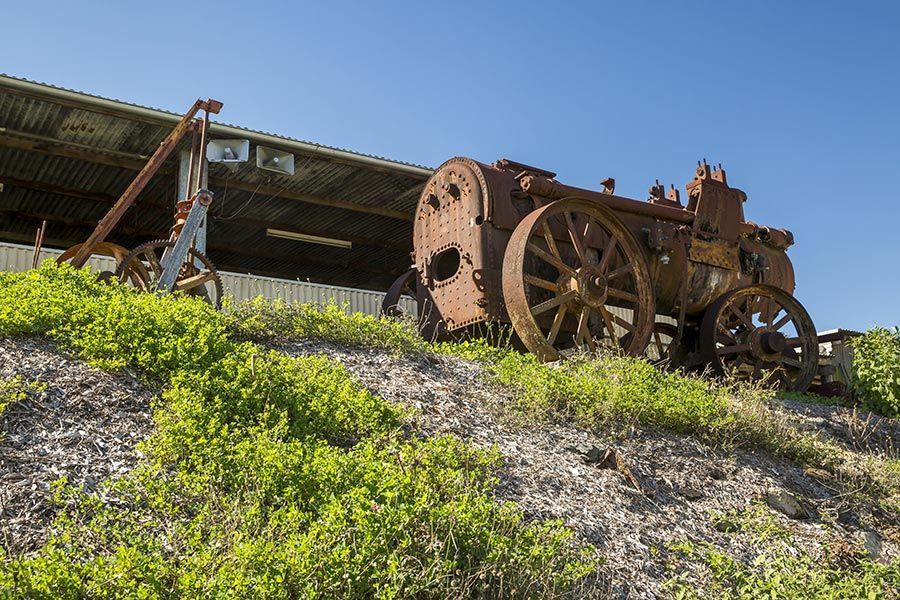 An Old Rusty Tractor Is Sitting on Top of A Grassy Hill — Stolzenberg Water Carriers in Gympie, QLD