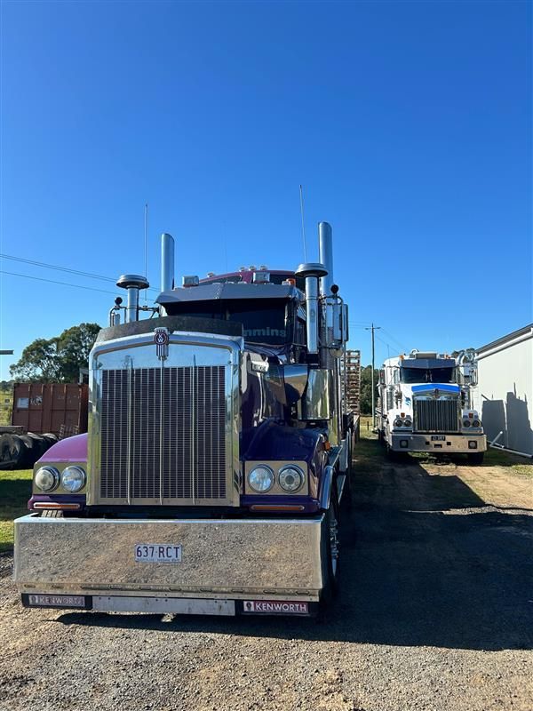 Two Semi Trucks Are Parked Next to Each Other in A Gravel Lot — Stolzenberg Water Carriers in Chatsworth, QLD