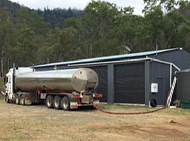 A Tanker Truck Is Parked in Front of A Building — Stolzenberg Water Carriers in Chatsworth, QLD