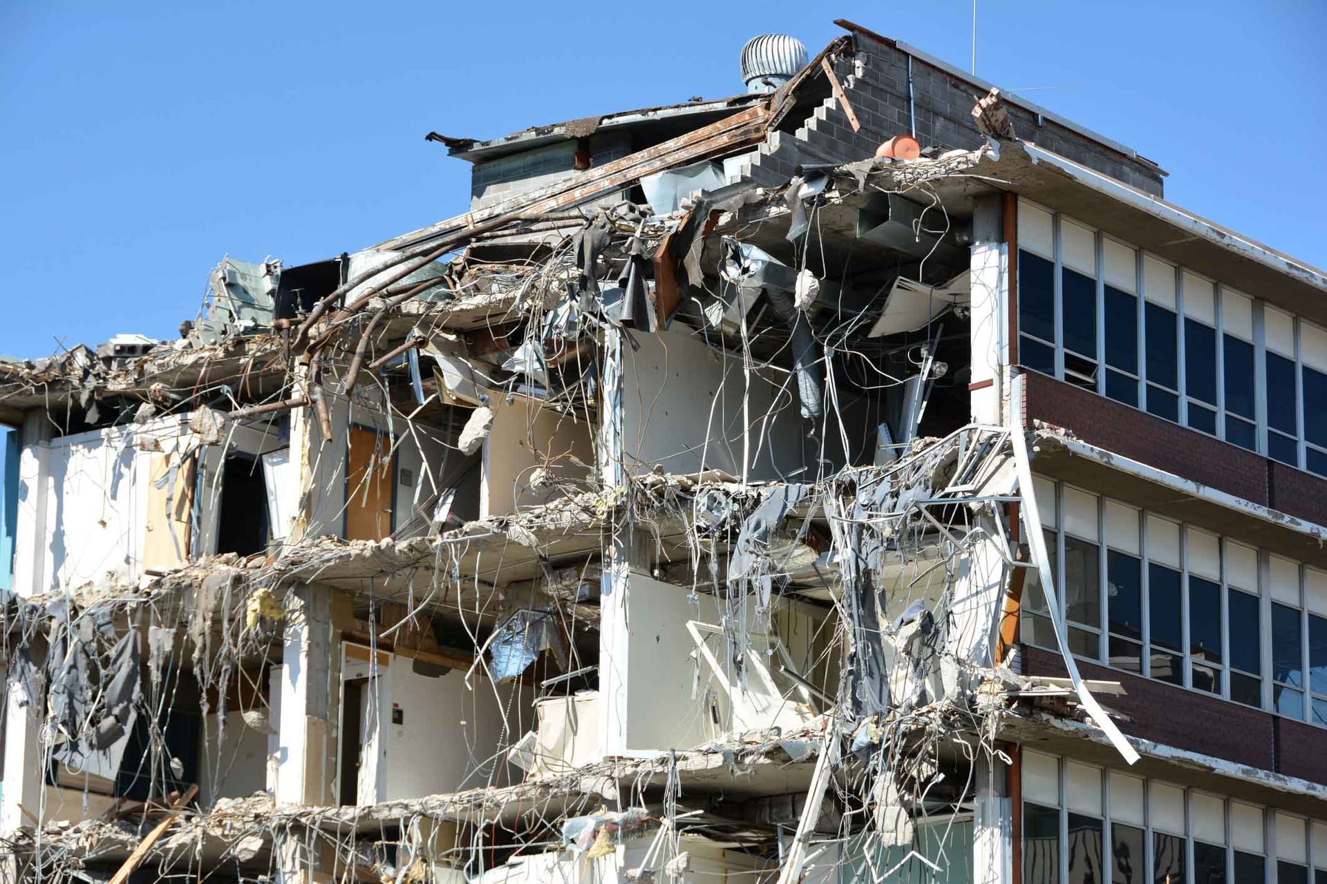 A Large Building Is Being Demolished On A Sunny Day – Port Pirie, SA - Flinders Earthmoving & Blue Metal Supplies