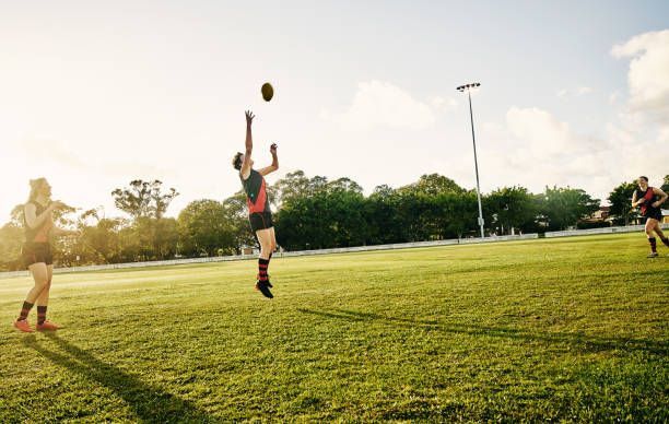 A Group Of People Are Playing A Game Of Rugby On A Field – Port Pirie, SA - Flinders Earthmoving & Blue Metal Supplies