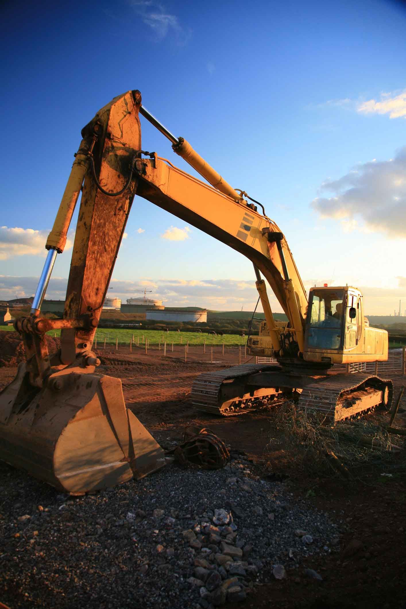 A Large Yellow Excavator Is Sitting On Top Of A Dirt Field – Port Pirie, SA - Flinders Earthmoving & Blue Metal Supplies