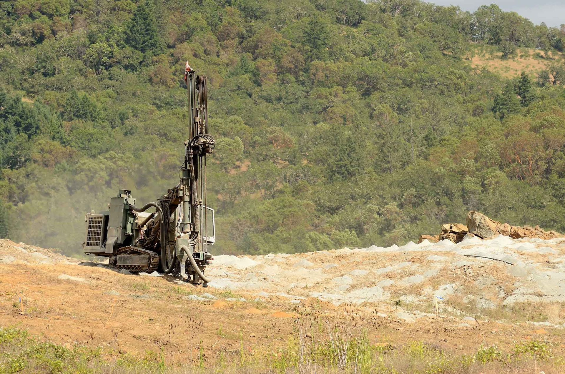 A Large Machine Is Drilling A Hole In The Ground In A Field – Port Pirie, SA - Flinders Earthmoving & Blue Metal Supplies