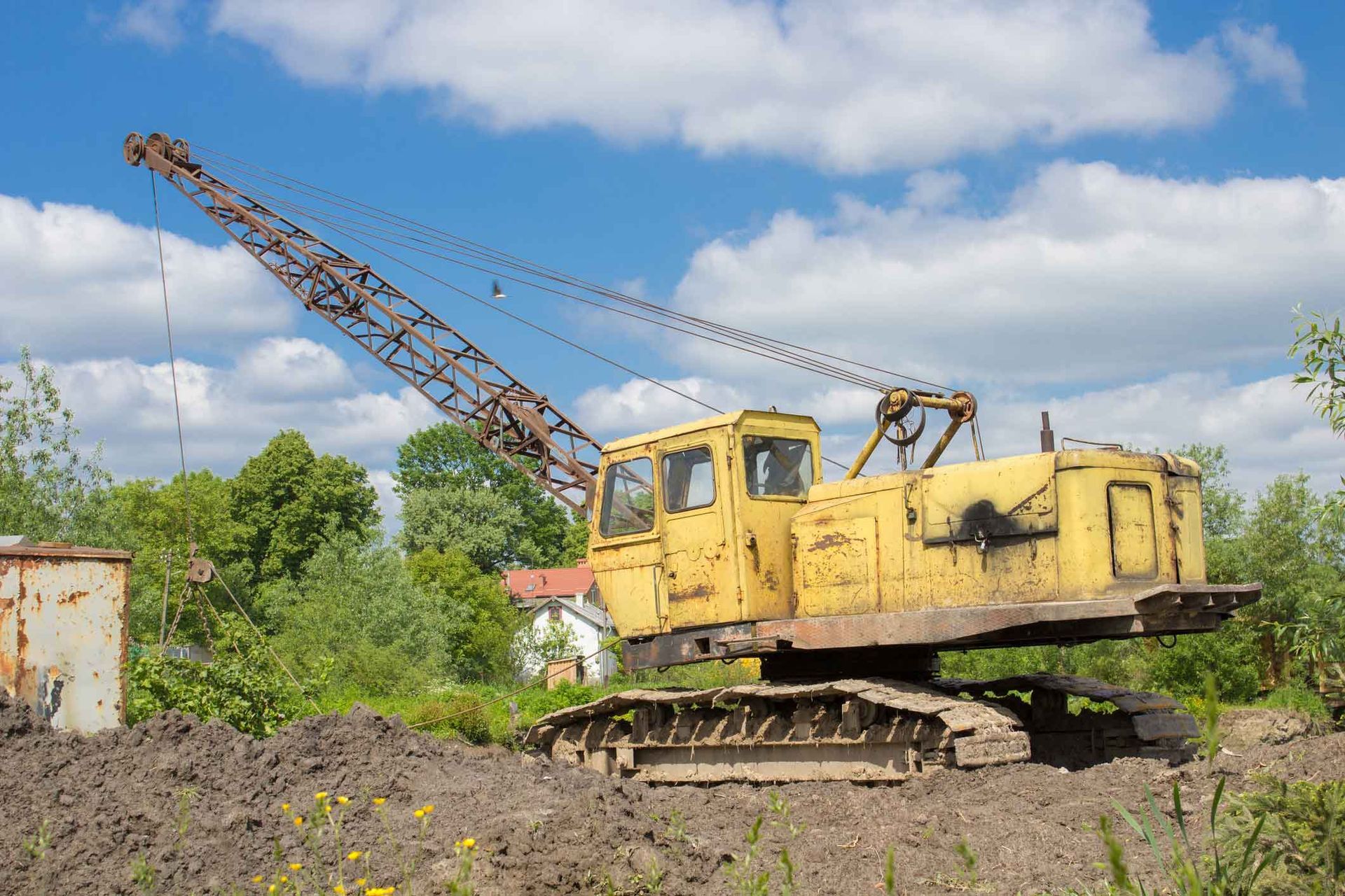 An Old Yellow Crane Is Sitting In The Middle Of A Field – Port Pirie, SA - Flinders Earthmoving & Blue Metal Supplies