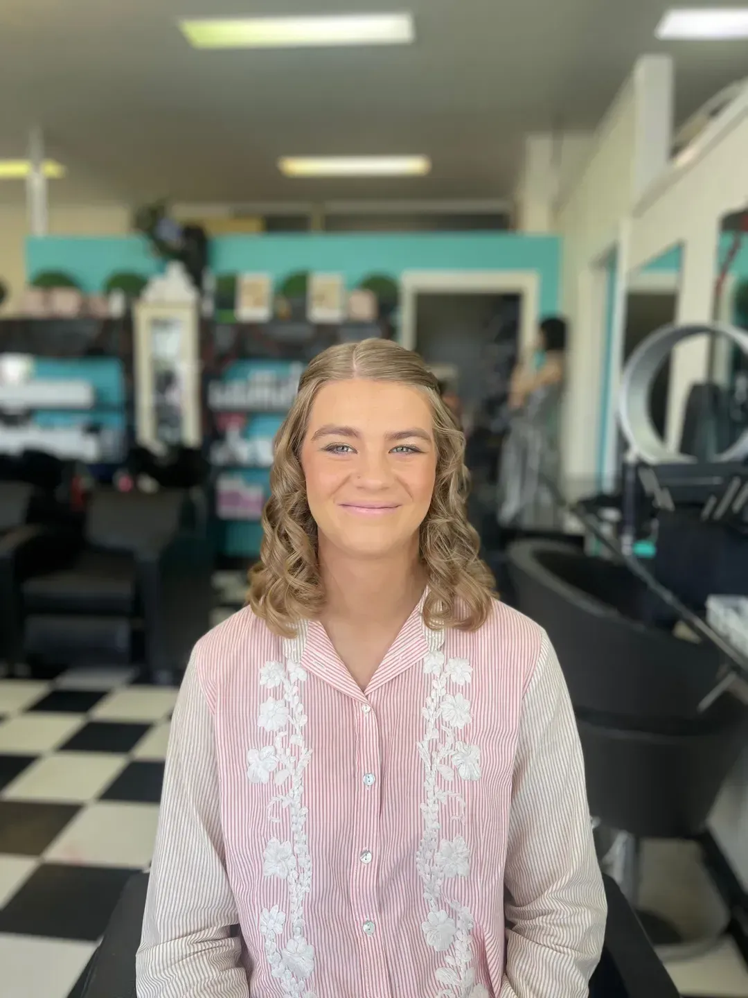 A Woman is Sitting in a Chair in a Hair Salon — Southside Hair & Beauty Design In South Tamworth, NSW
