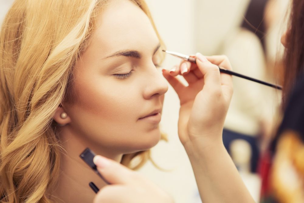 A Woman is Getting Her Eyebrows Painted by a Makeup Artist — Southside Hair & Beauty Design In South Tamworth, NSW