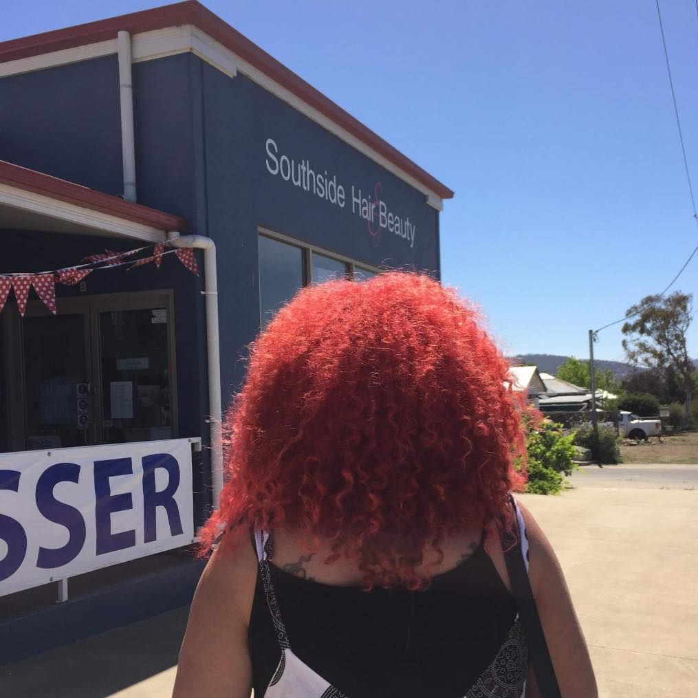 A Woman With Red Hair Stands in Front of Southside Hair Beauty — Southside Hair & Beauty Design In South Tamworth, NSW