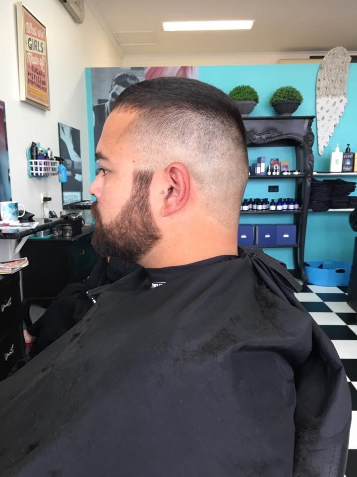 A Man With a Beard is Getting His Hair Cut at a Barber Shop — Southside Hair & Beauty Design In South Tamworth, NSW