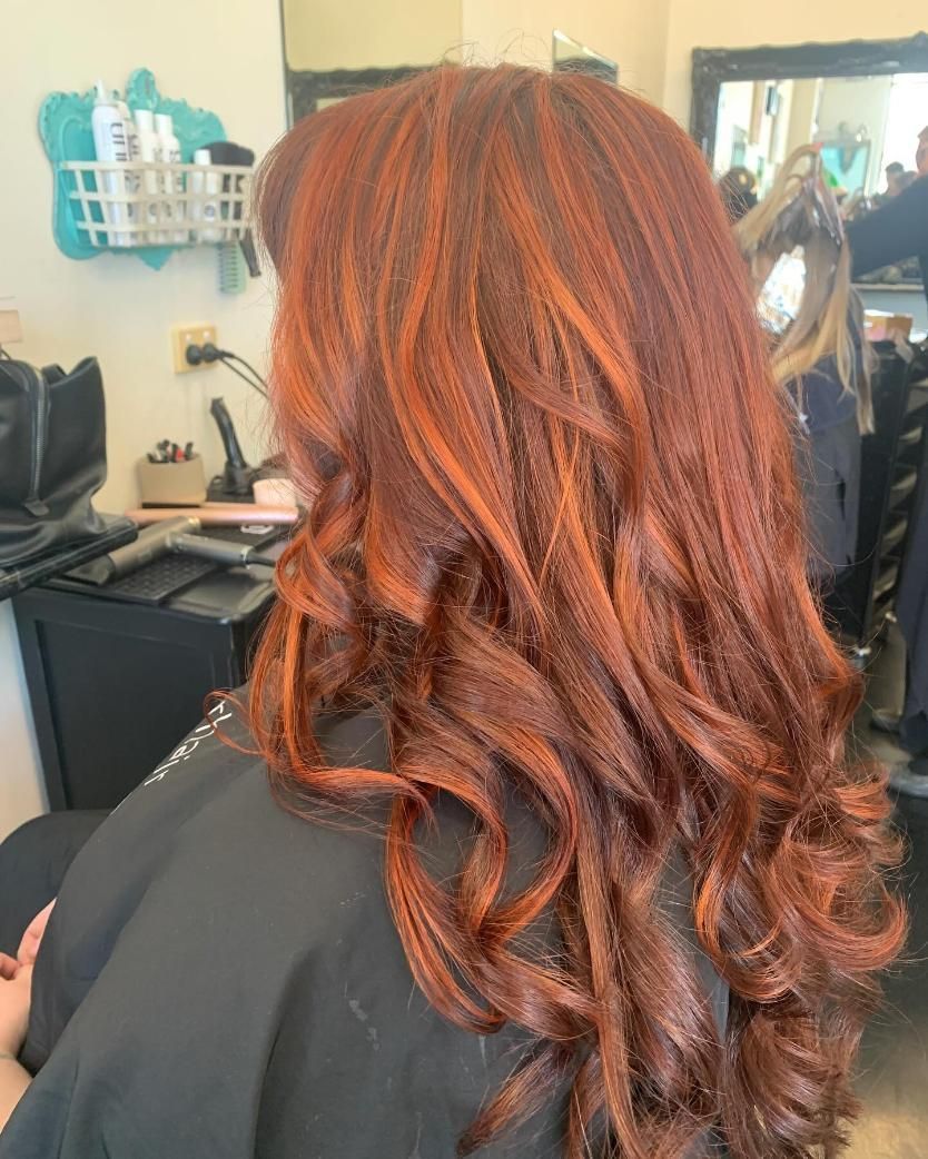 A Woman With Curlers in Her Hair is Smiling While Sitting in a Chair — Southside Hair & Beauty Design In South Tamworth, NSW