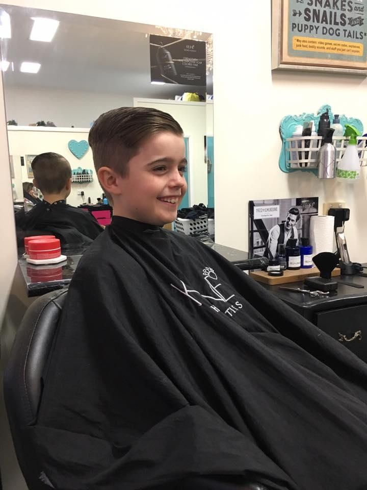 A Young Boy is Getting His Hair Cut at a Barber Shop — Southside Hair & Beauty Design In South Tamworth, NSW