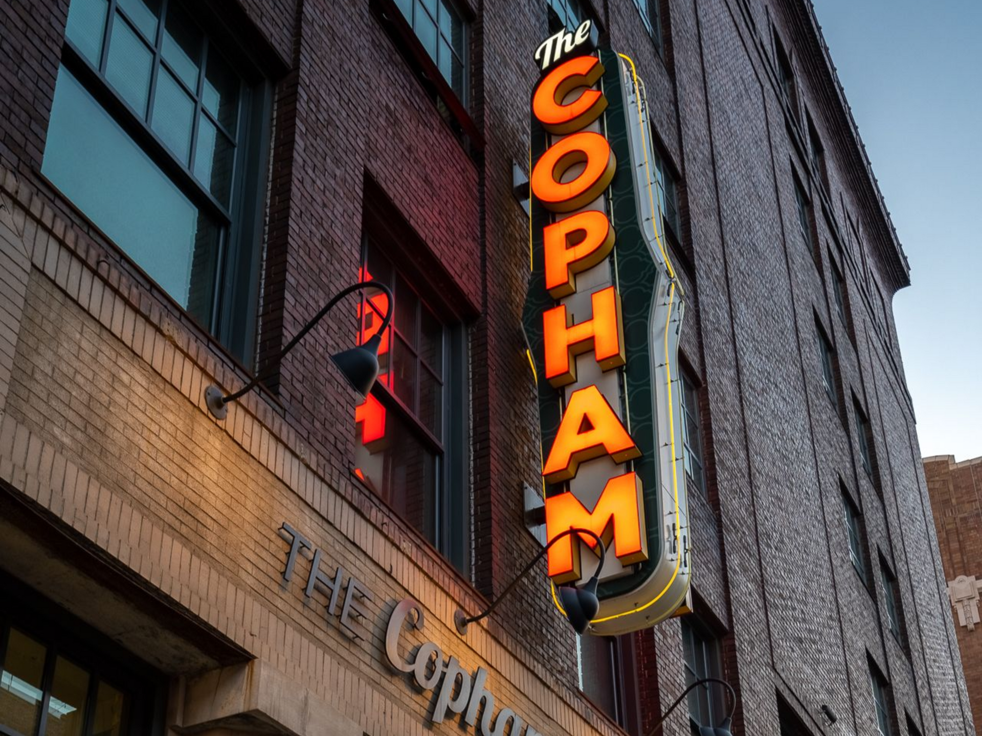 The iconic neon and illuminated The Copham sign located right above the main entrance.