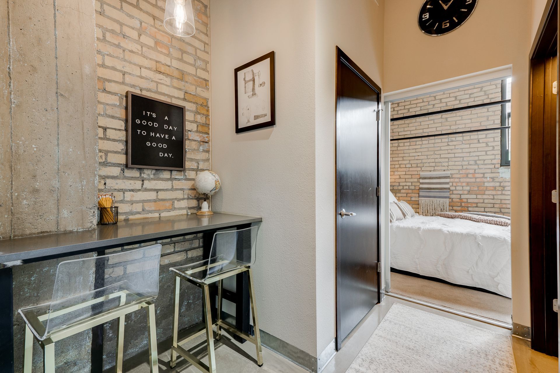 Large windows provide natural light into the bedroom and living space.
