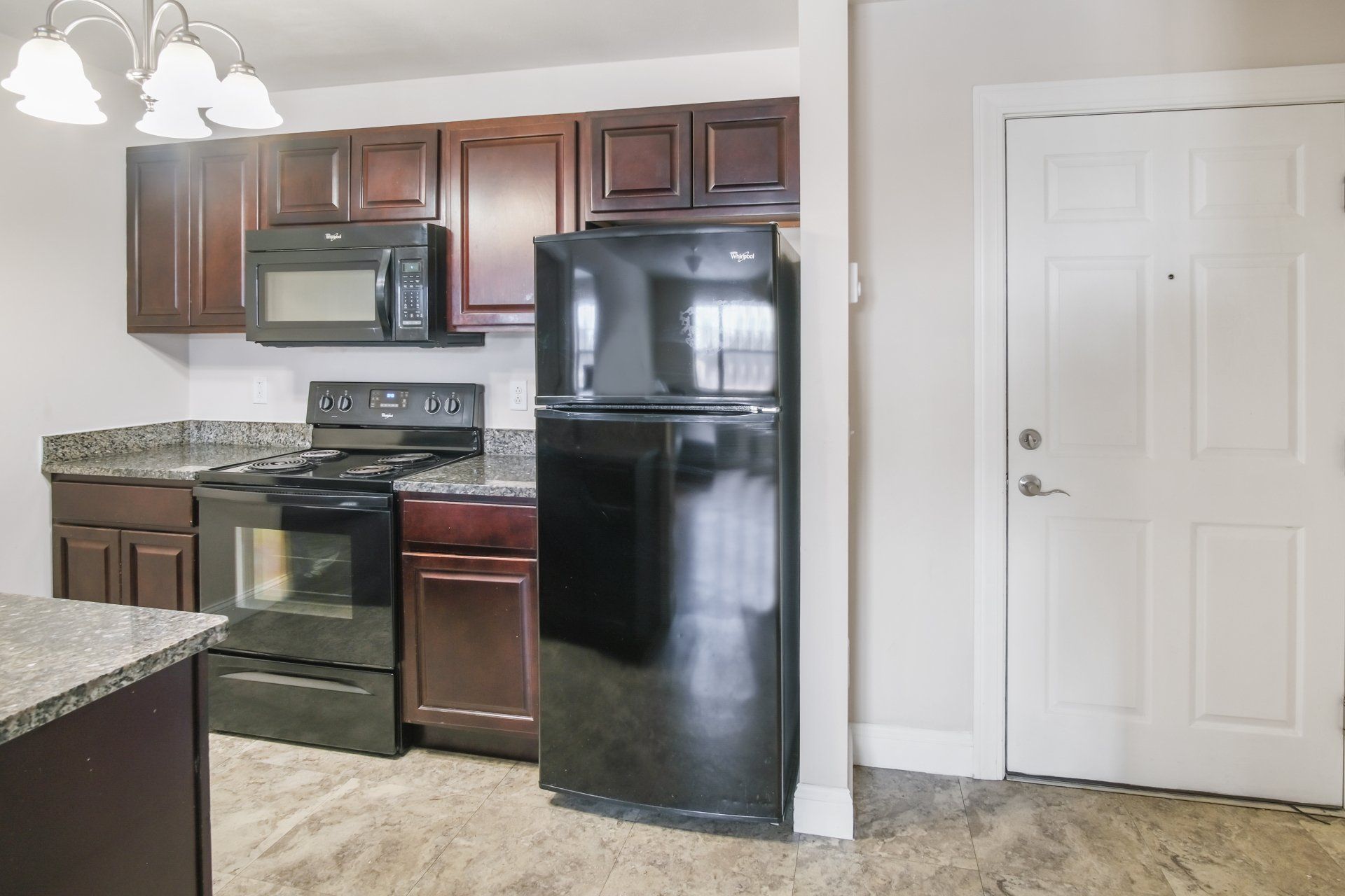 full kitchen with stove, microwave, oven, and refrigerator