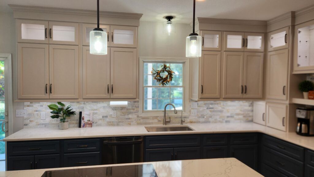 A kitchen with a sink , cabinets , and a window.