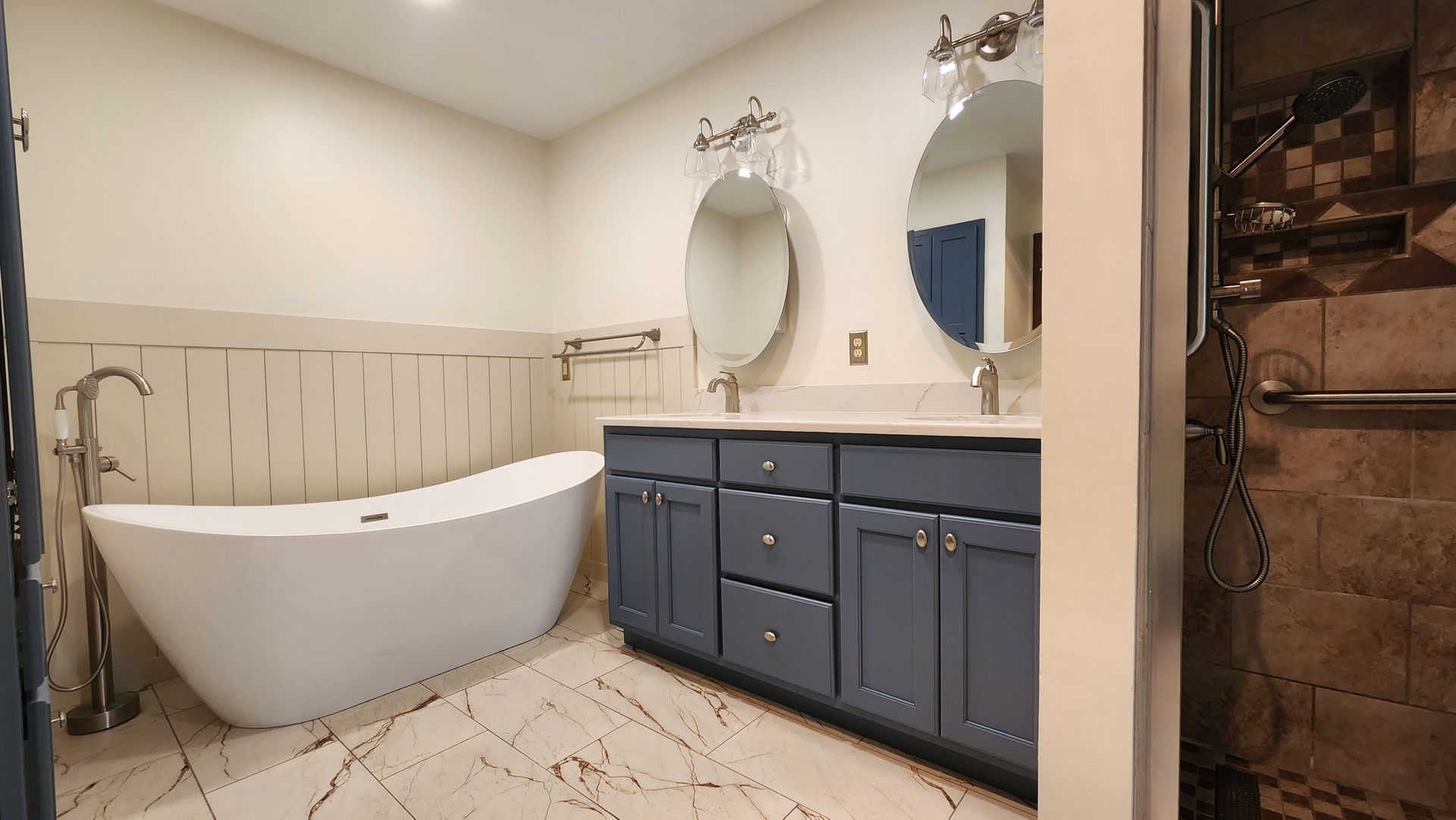 A bathroom with a bathtub , two sinks , and two mirrors.