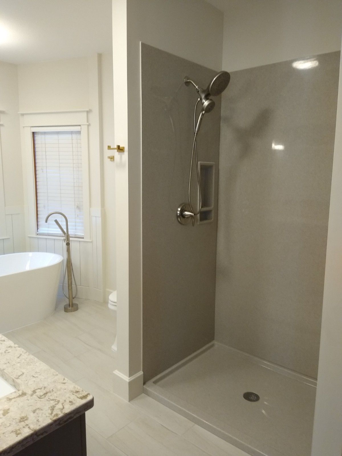 A bathroom with a walk in shower and a bathtub.