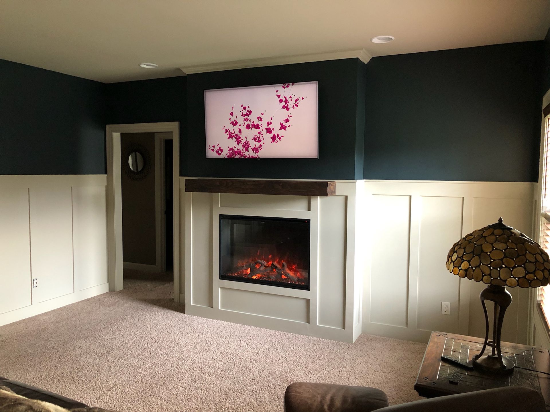 A living room with a fireplace and a lamp