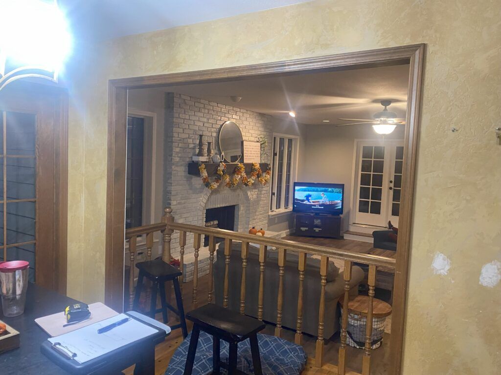 A living room with a fireplace , couch , and television.